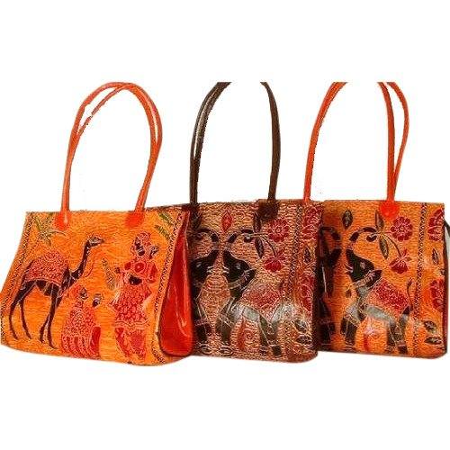 Hand-painted leather tote bags with folk motifs