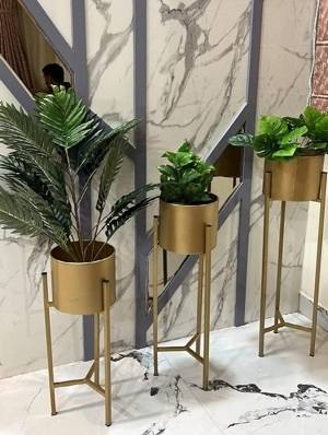Gold metal planters on tall stands