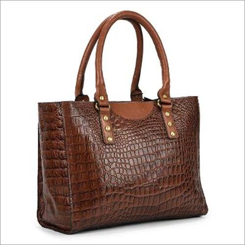 Crocodile-embossed brown leather handbag