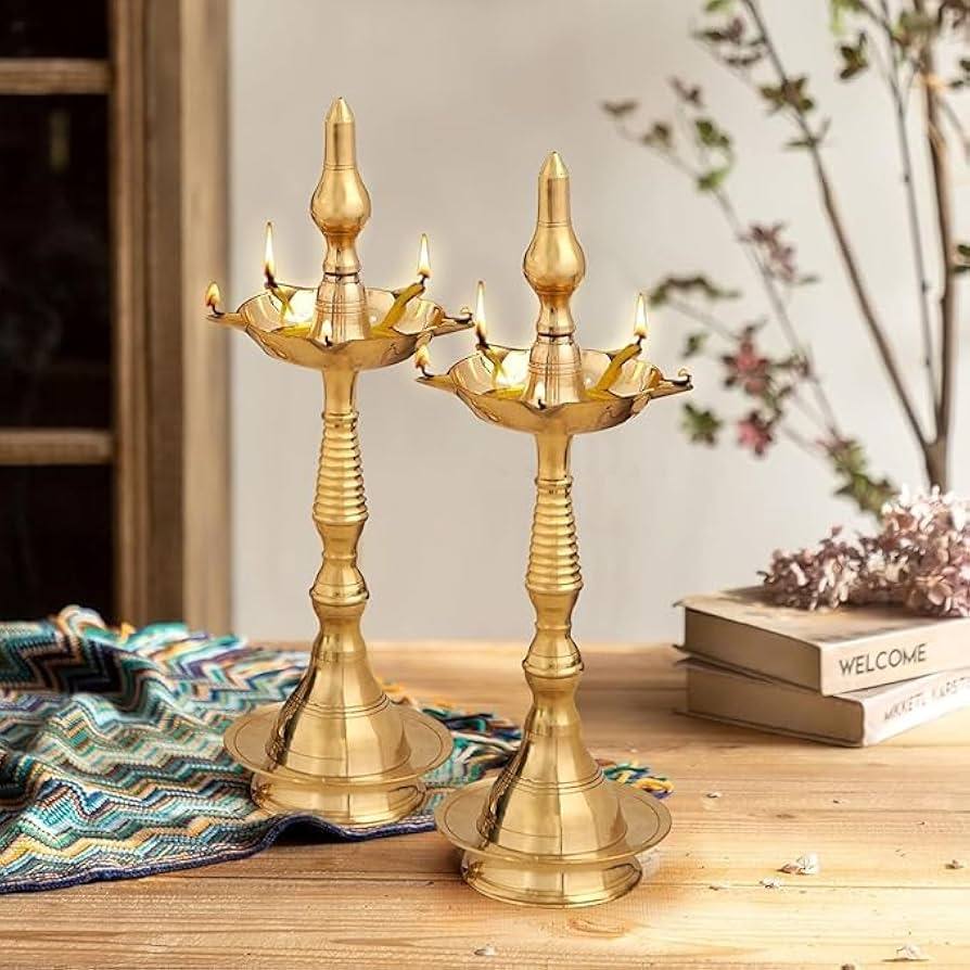 Traditional brass oil lamps with lit wicks