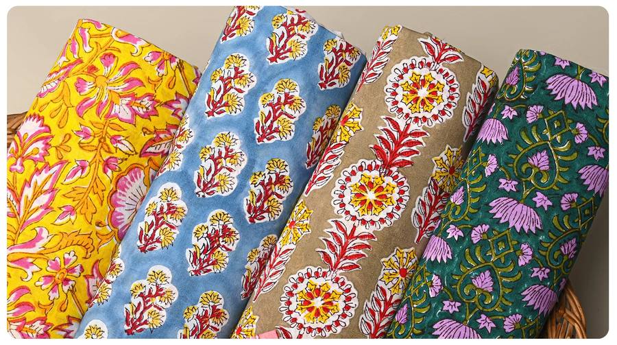 Rolled bolts of Sanganeri hand block-printed floral fabric