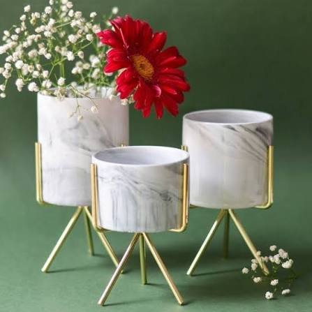 Marble planters on gold stands with flowers