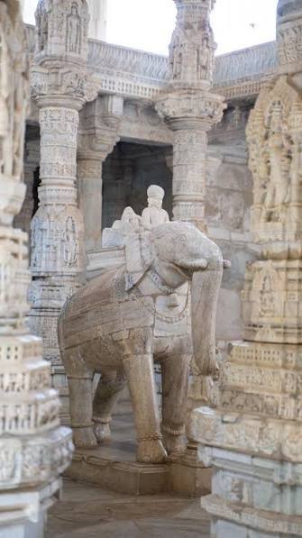 Carved white marble elephant sculpture in a temple