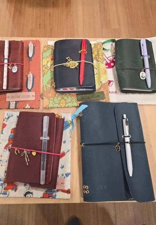 Assorted leather journals with pen loops and charms